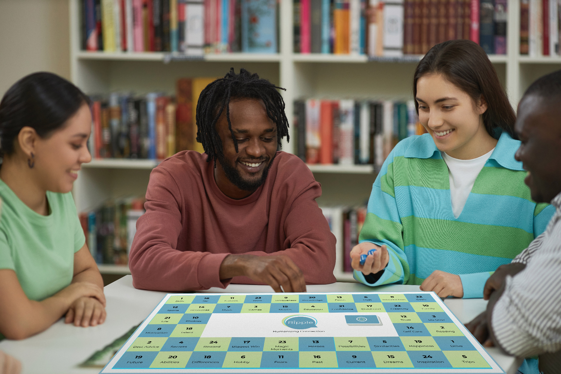 A group of friends gathered around the Let's Ripple™ board in a cozy setting